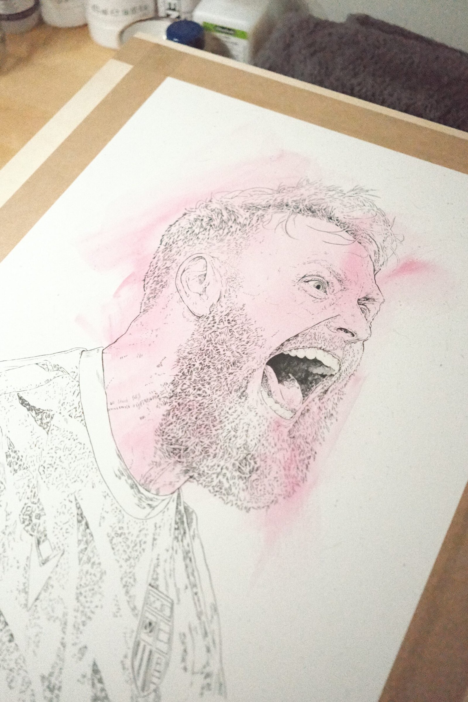 Detail of the early line drawing and pale pink background washes in a portrait of Stoke City goalkeeper Viktor Johansson.